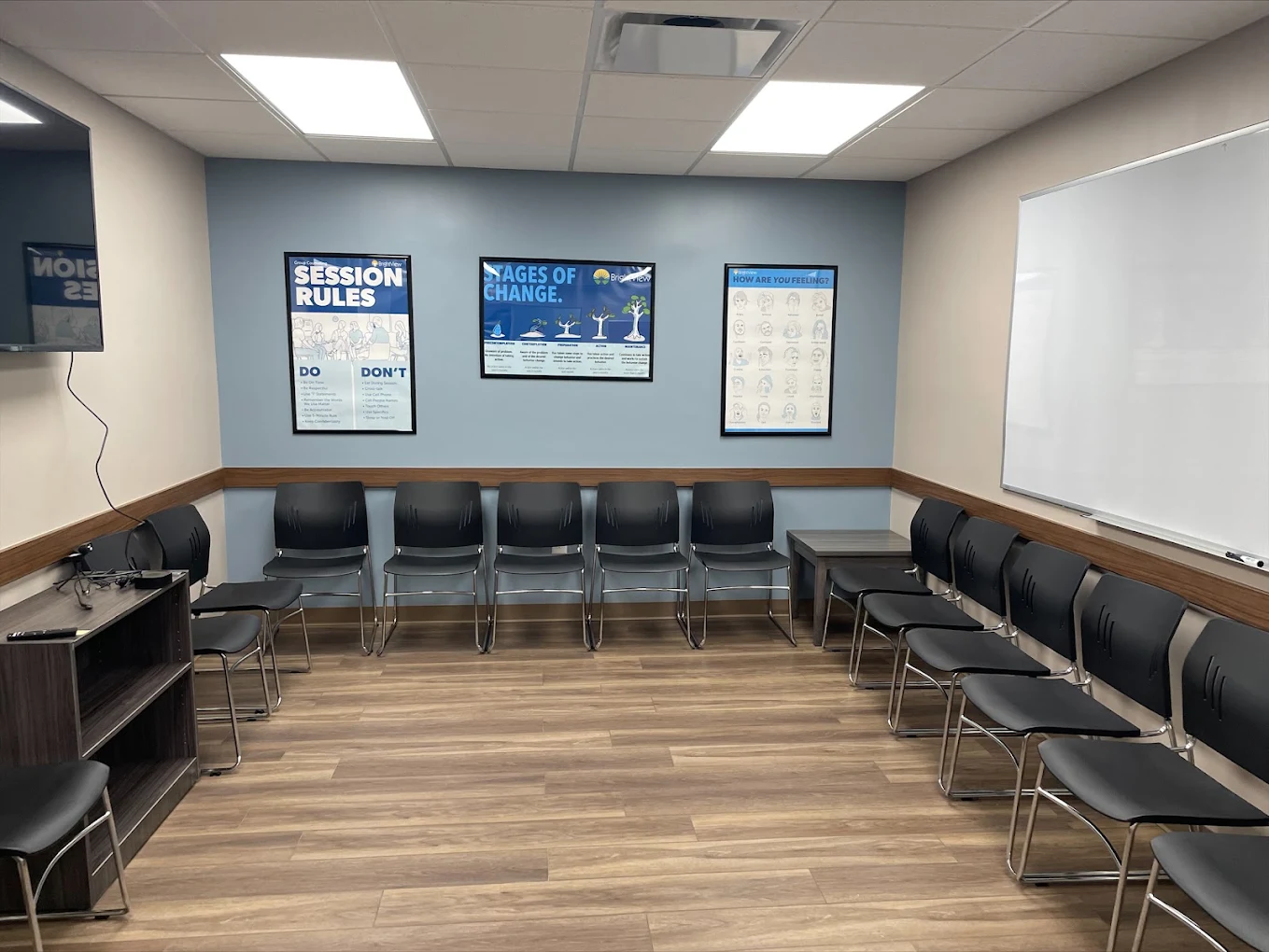 BrightView Fredericksburg group room with chairs, whiteboard, TV, and recovery education posters