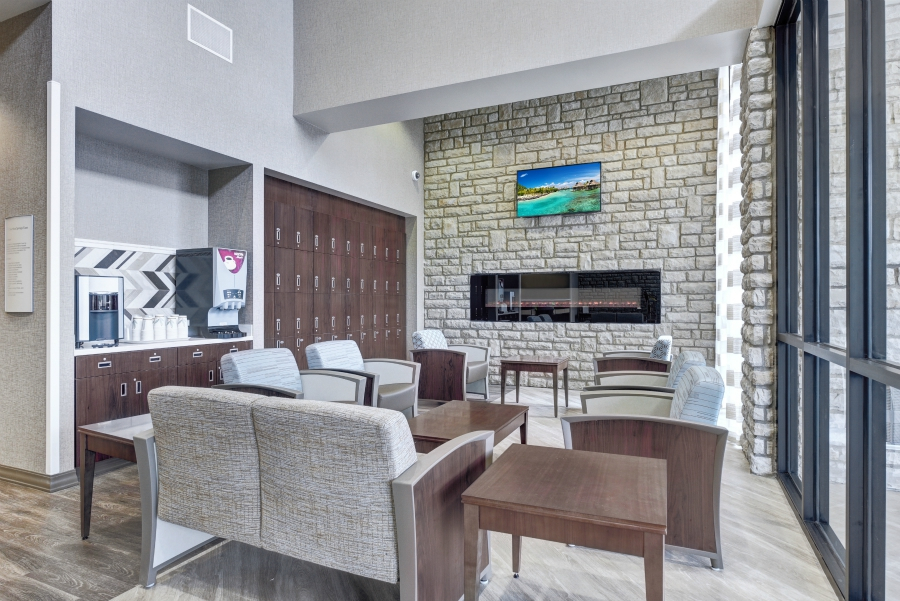 Rehab lounge with fireplace, lockers, and drink station