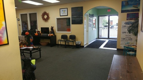 Lobby with chairs, decorations, and an open entrance
