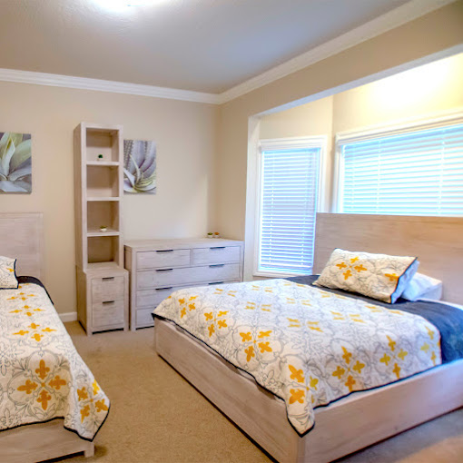 Bedroom with two beds and a dresser.
