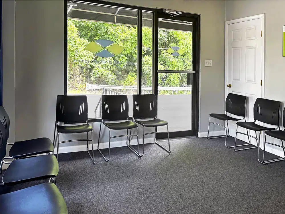 Waiting area with chairs near large window and glass door