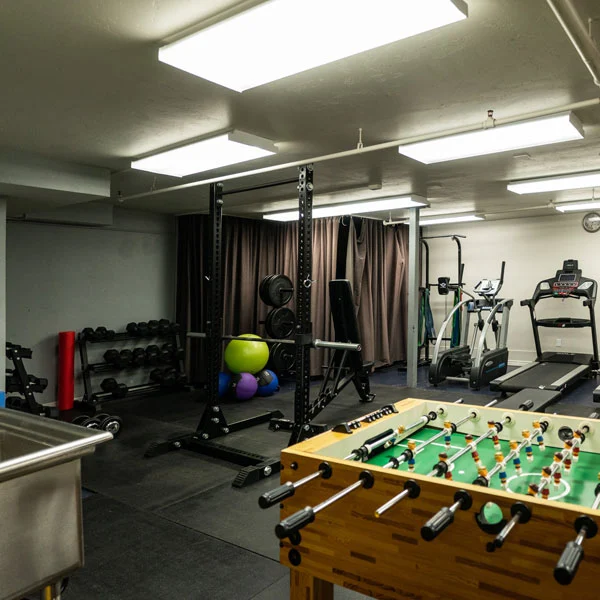 Game room with treadmills, weights, and football table