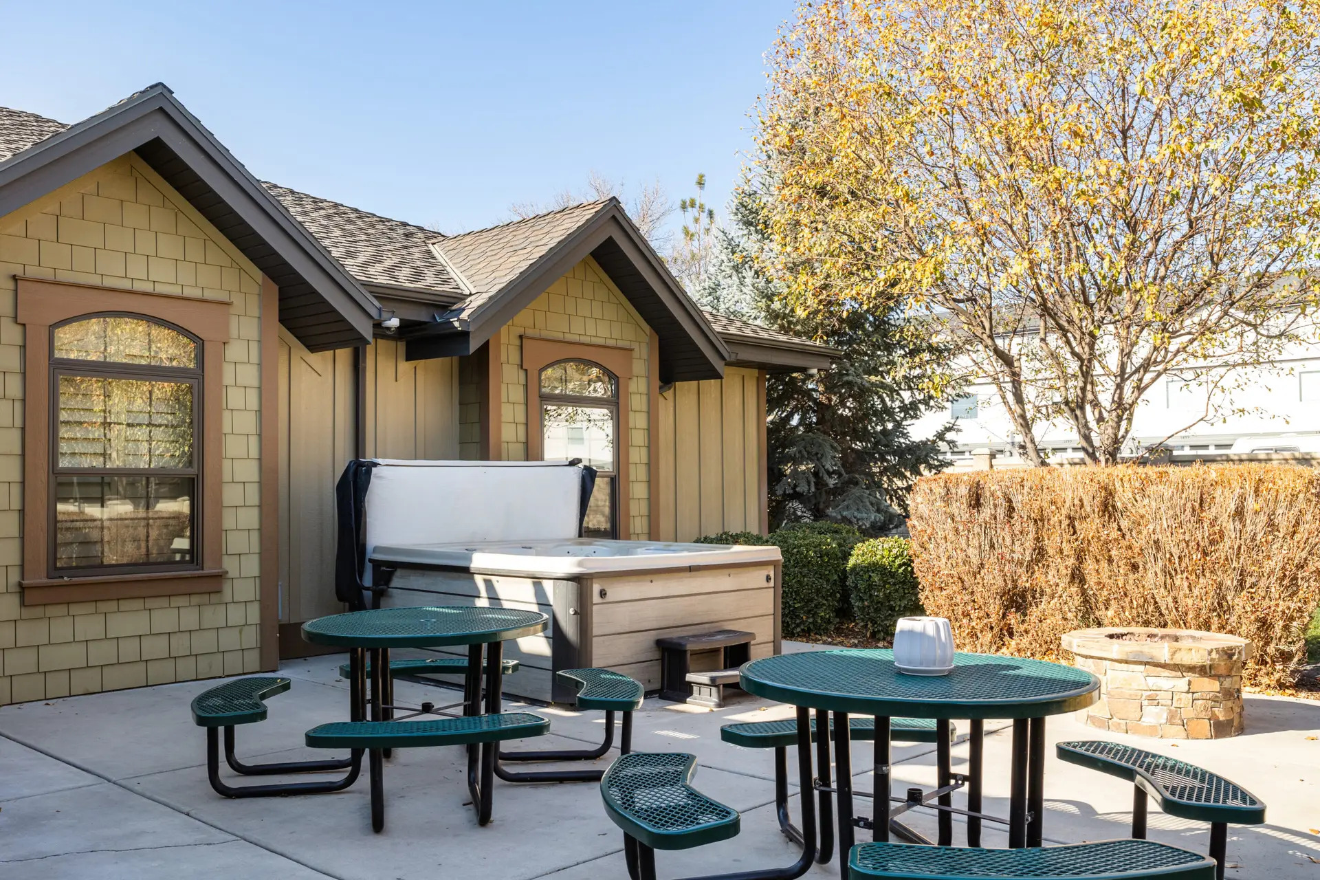 Outdoor seating next to hot tub and fire pit