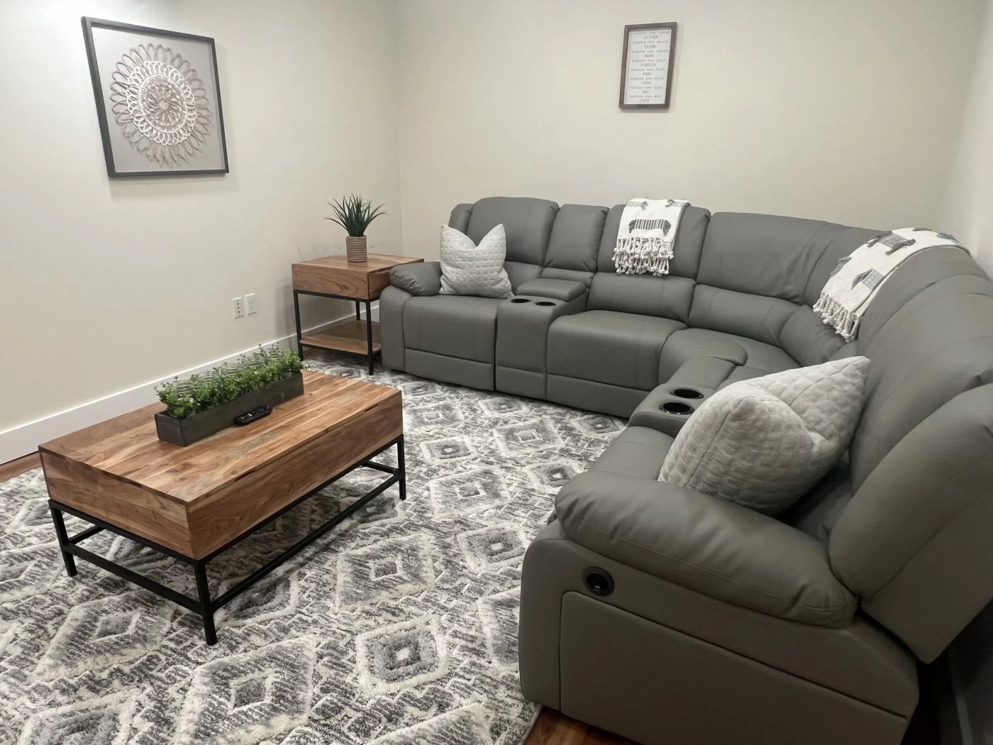 Cozy lounge with sectional sofa, coffee table, and neutral decor