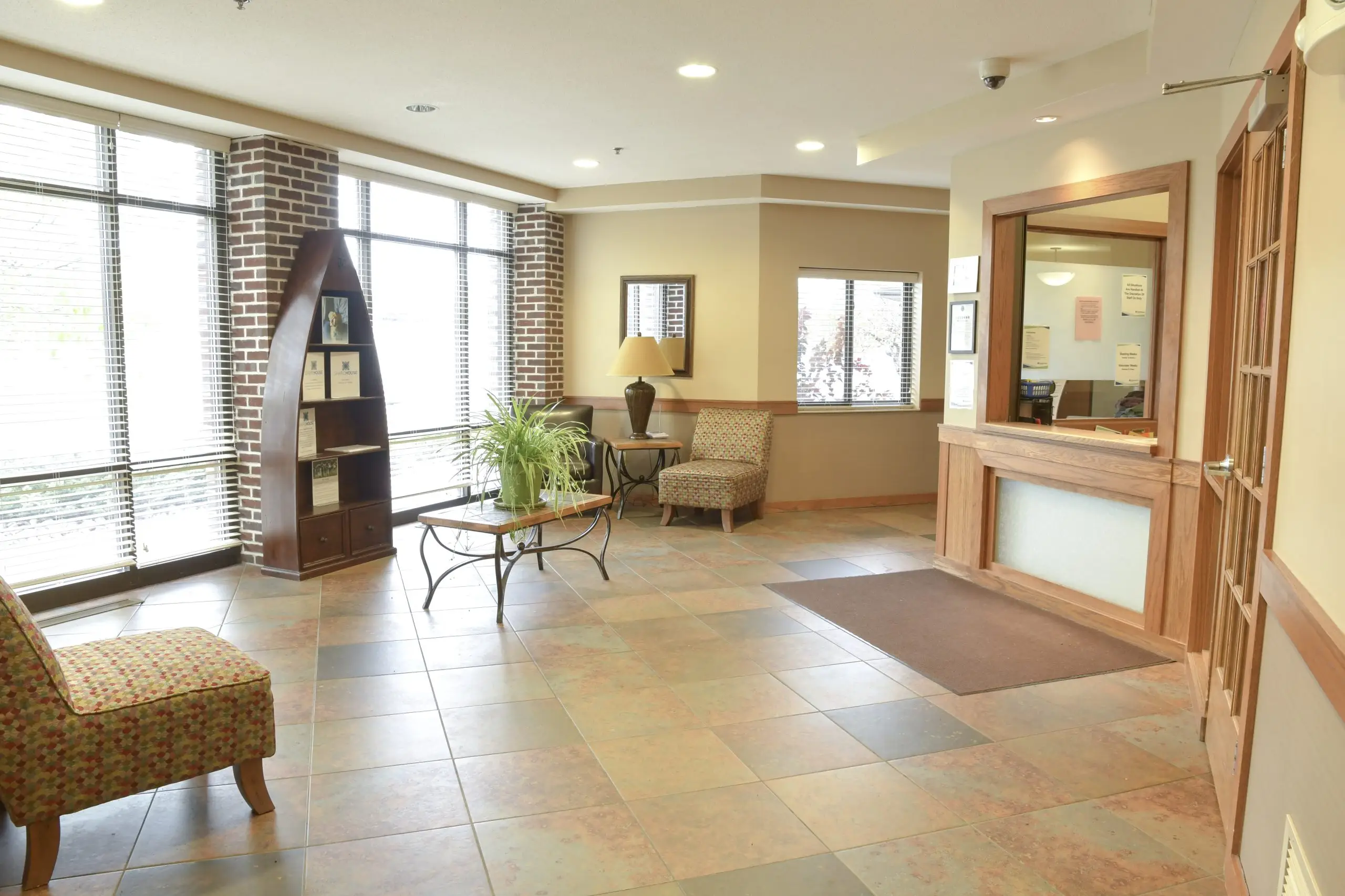 Welcoming lobby with chairs, windows, and reception desk