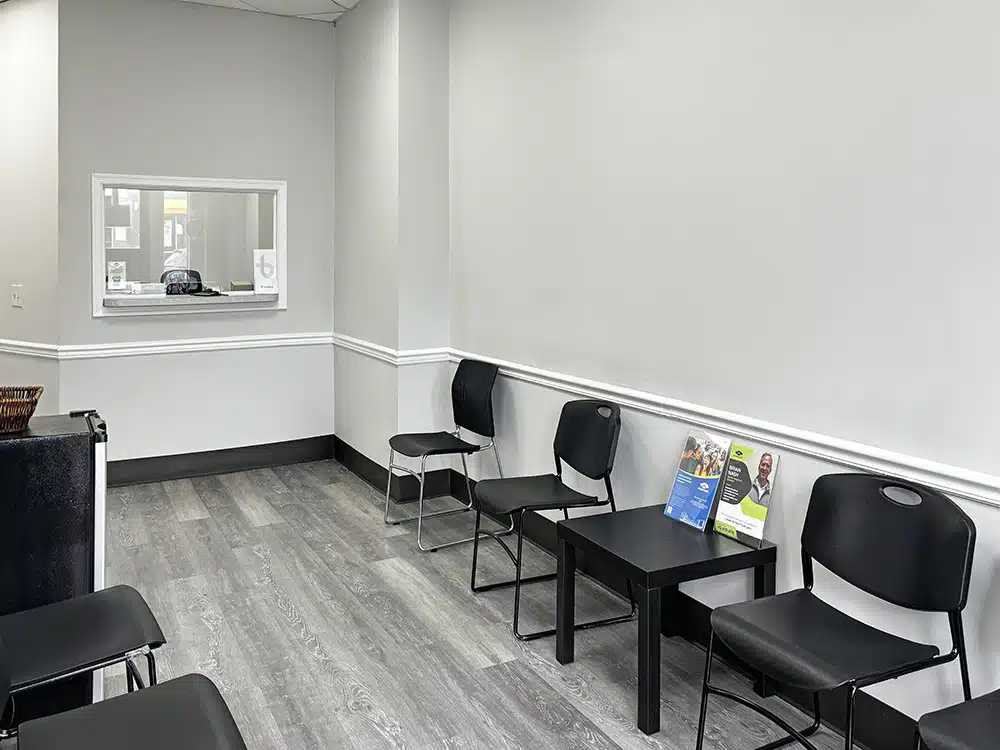 Small waiting room with chairs and check-in window
