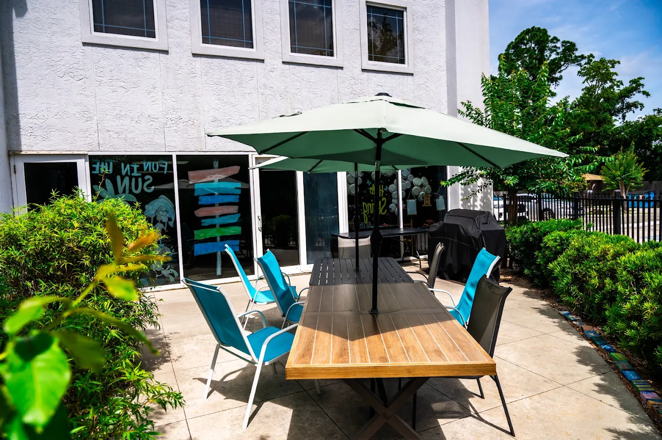 Outdoor patio with dining table, chairs, and large umbrella