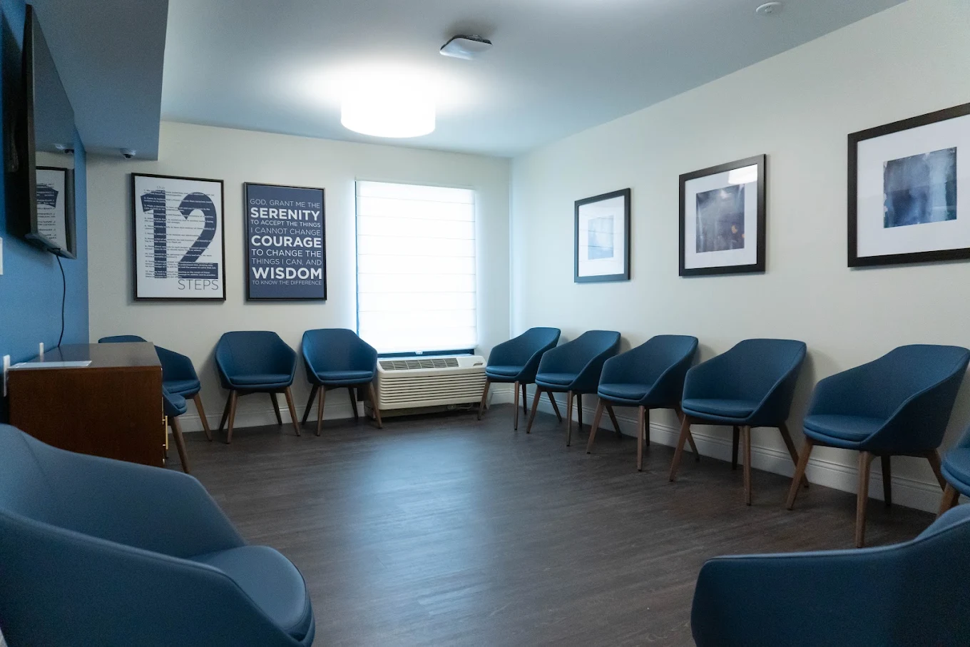 Group therapy room with blue chairs arranged in a circle
