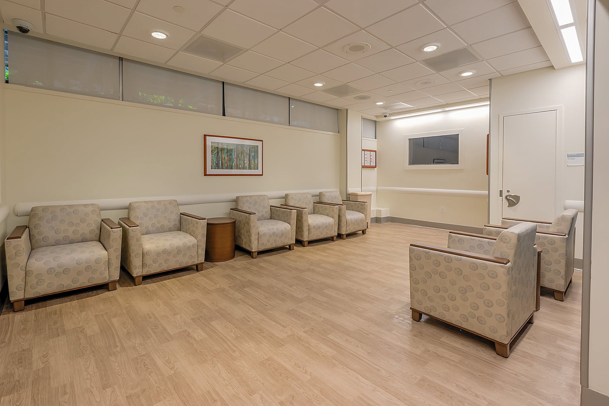 Waiting room with upholstered chairs and wood flooring