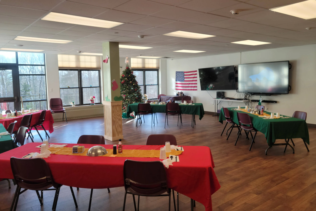 Group room with tables, chairs, TV, and open floor space