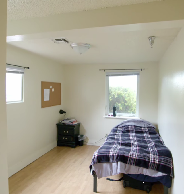 Simple single bedroom with bed and window view