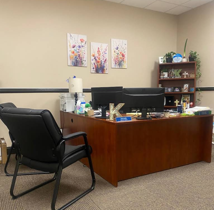 Staff office with desk, computer, and guest chair