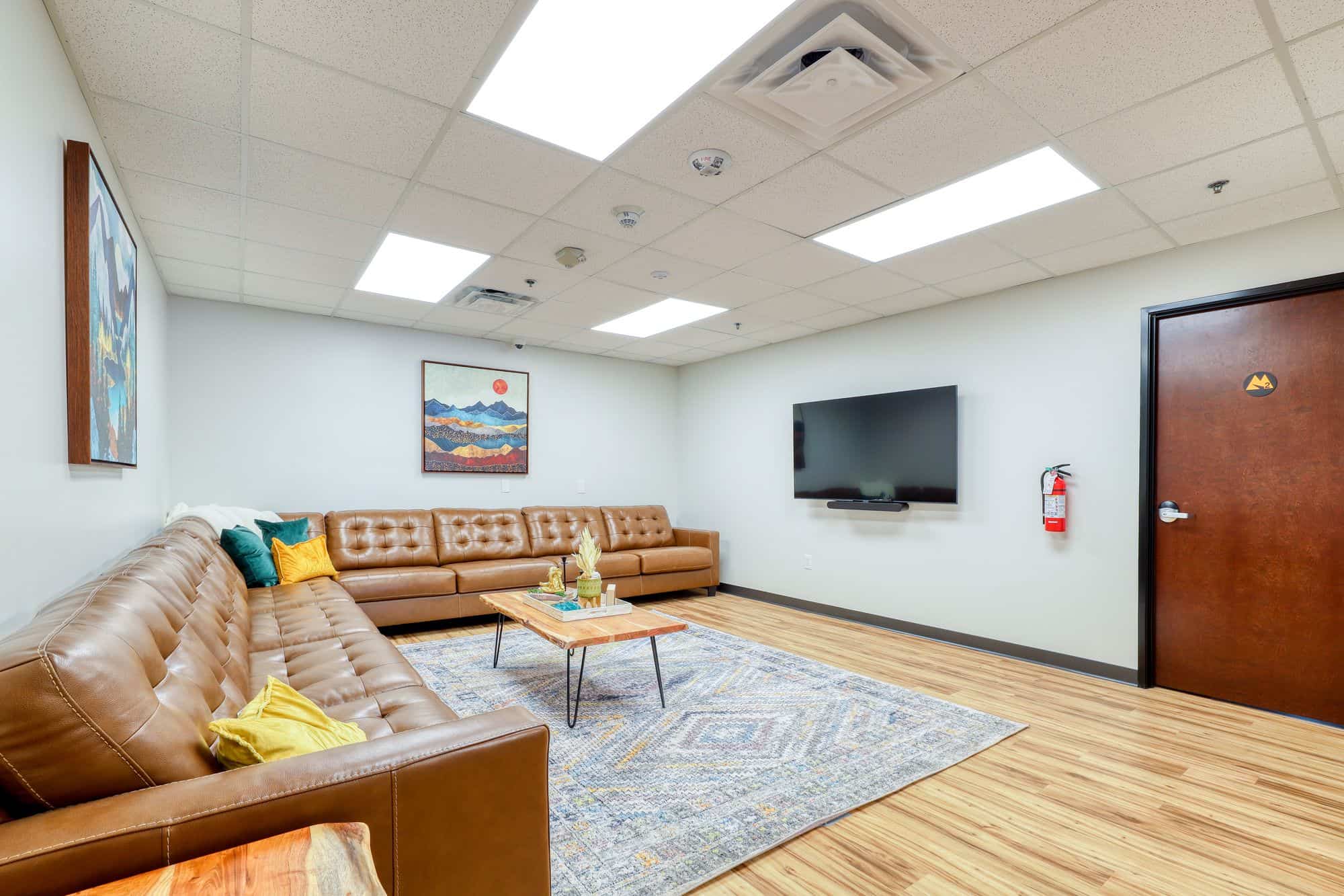 Lounge with leather sectional, TV, and coffee table