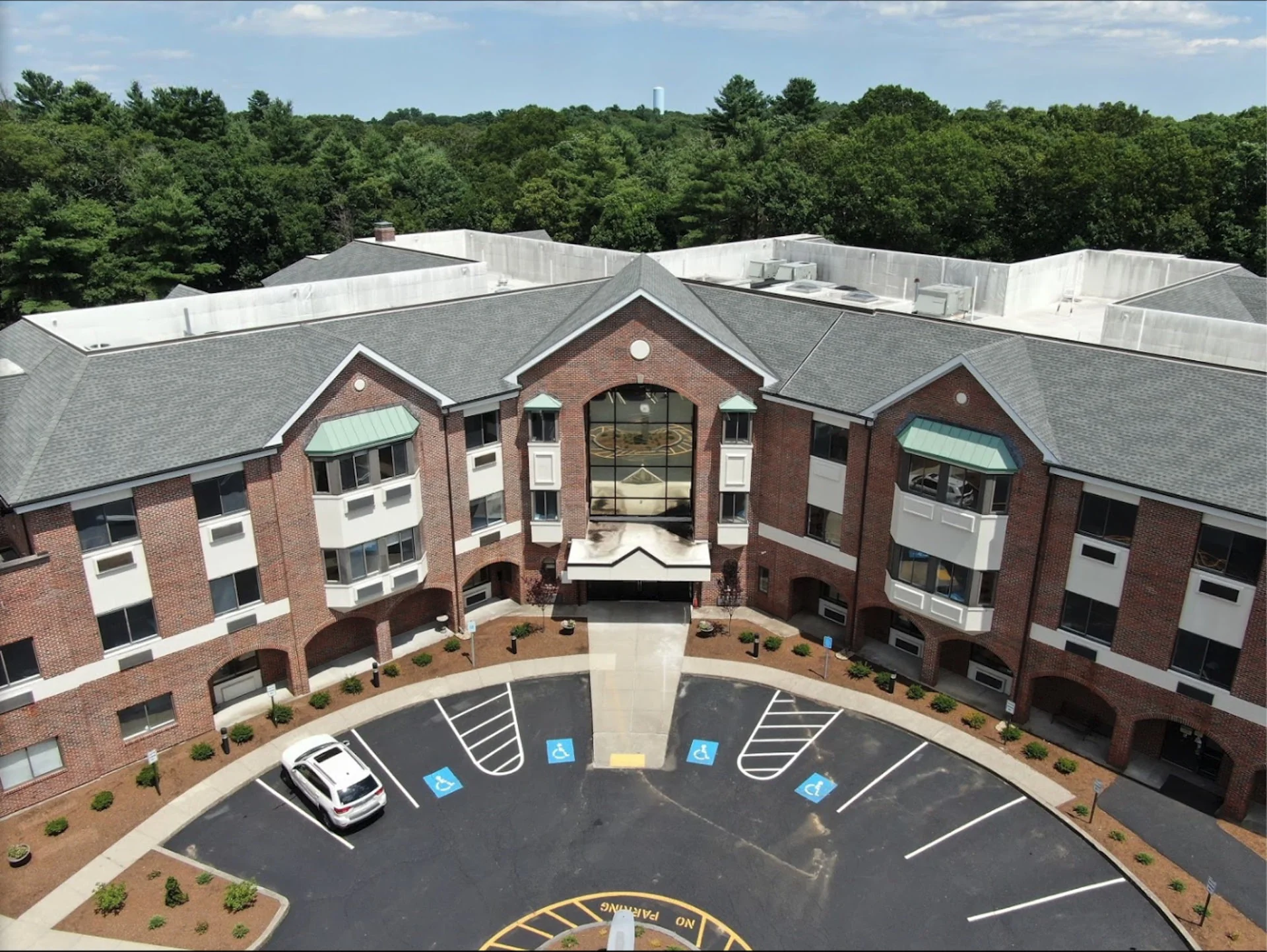 Aerial view of a large rehab facility with greenery.
