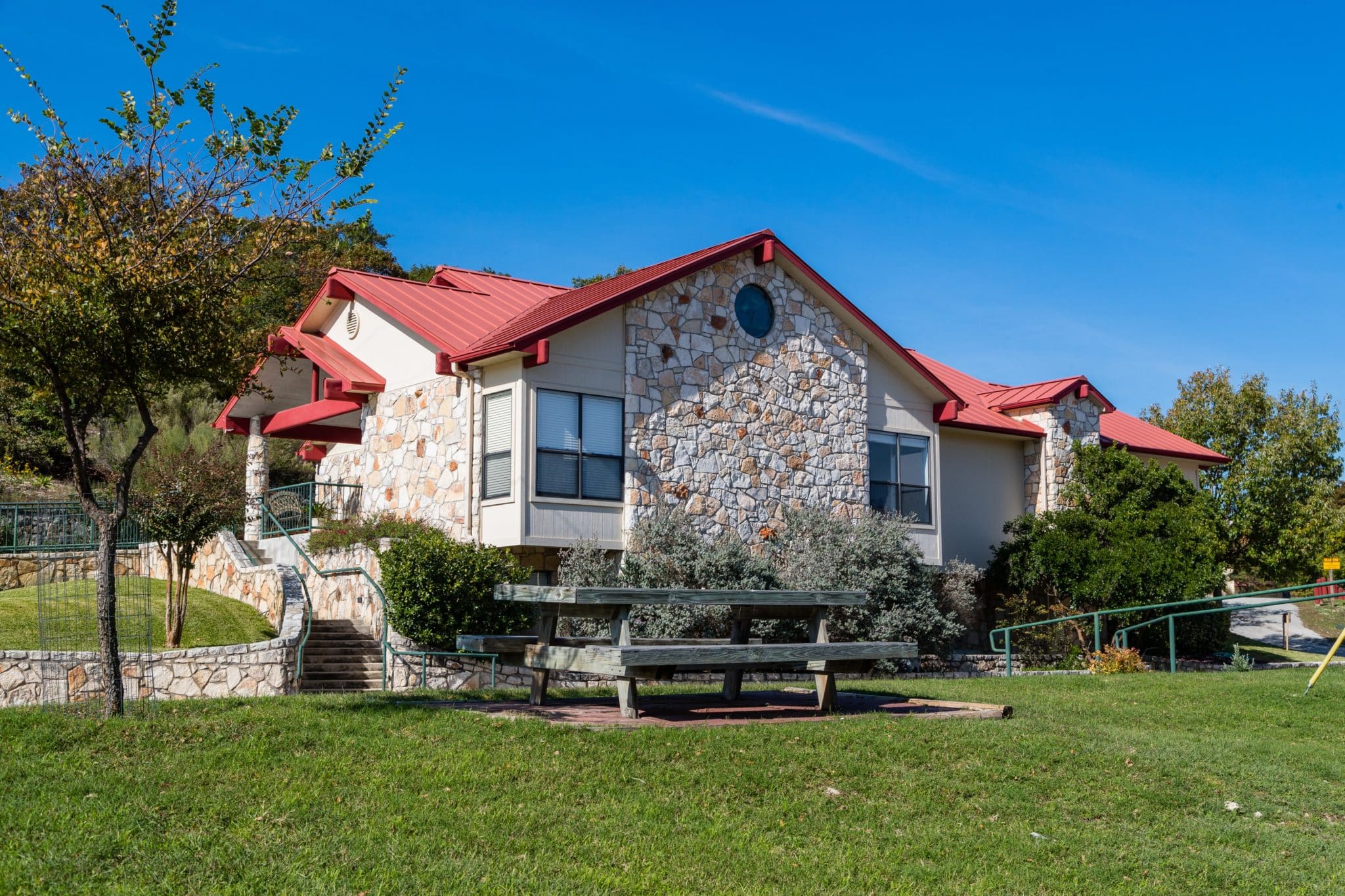 Stone-accented building near lush landscape