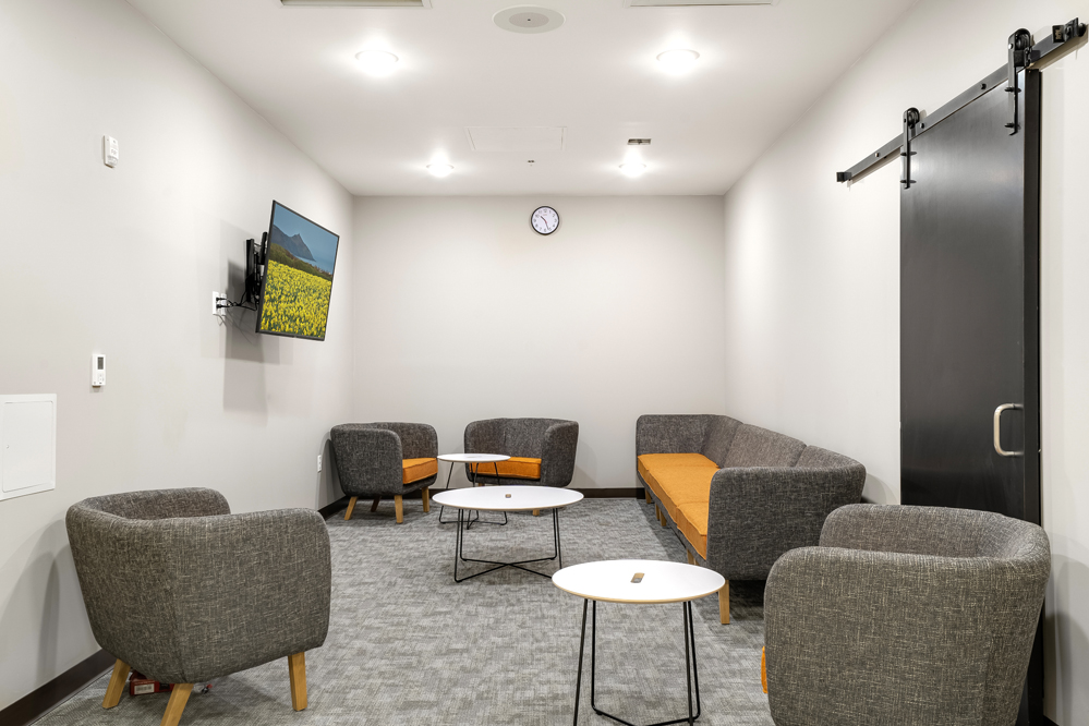 Comfortable group lounge with chairs and TV seating