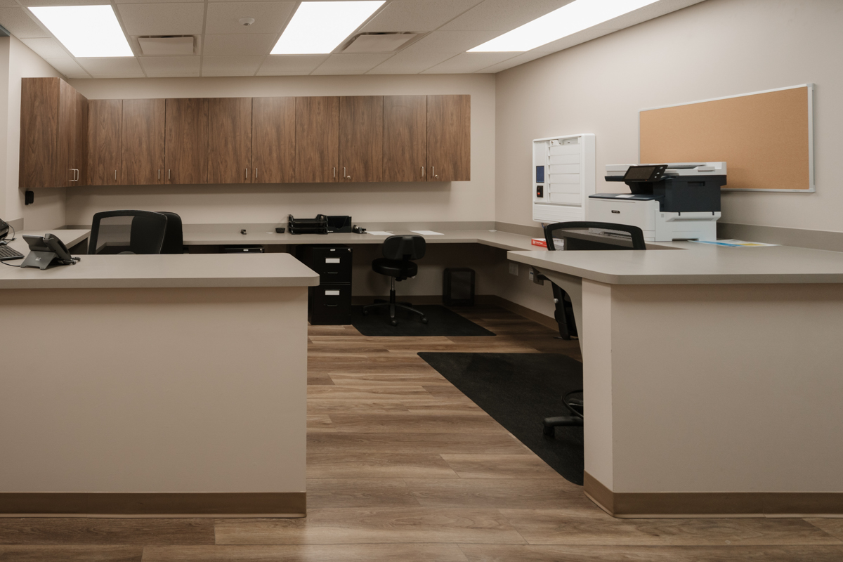 Nurses station with work counters, cabinets, and printer