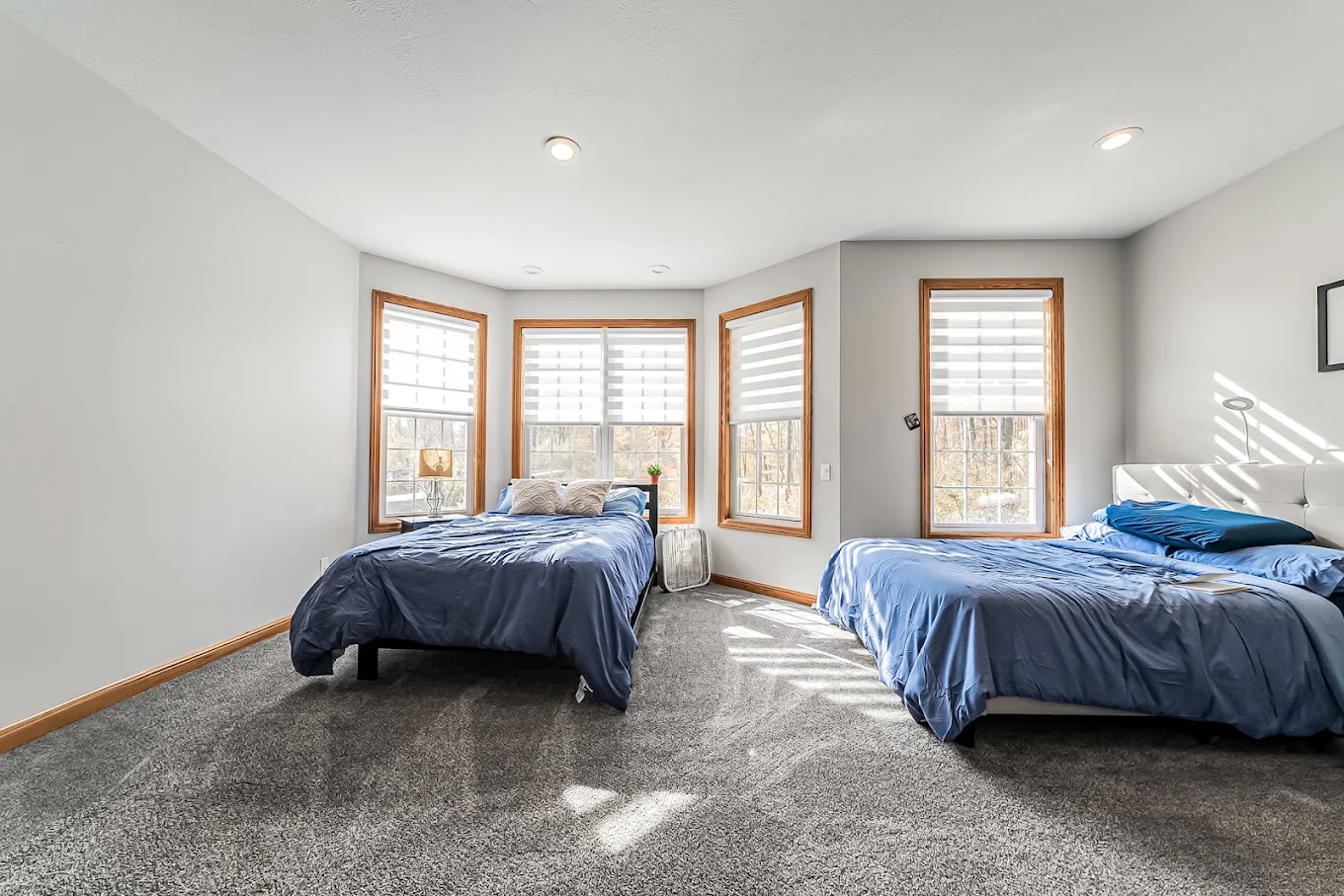 Shared bedroom with two beds and large windows