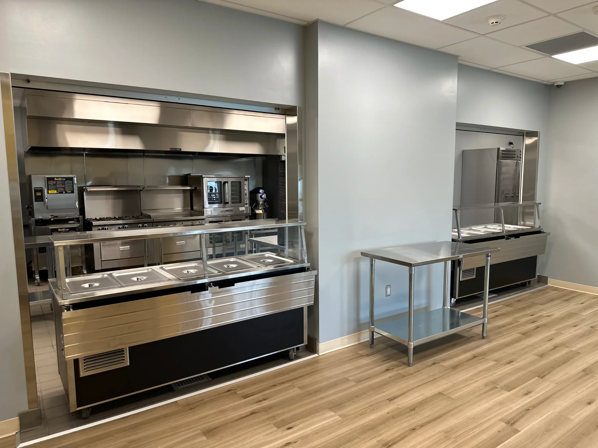 Commercial cafeteria serving area with food stations.