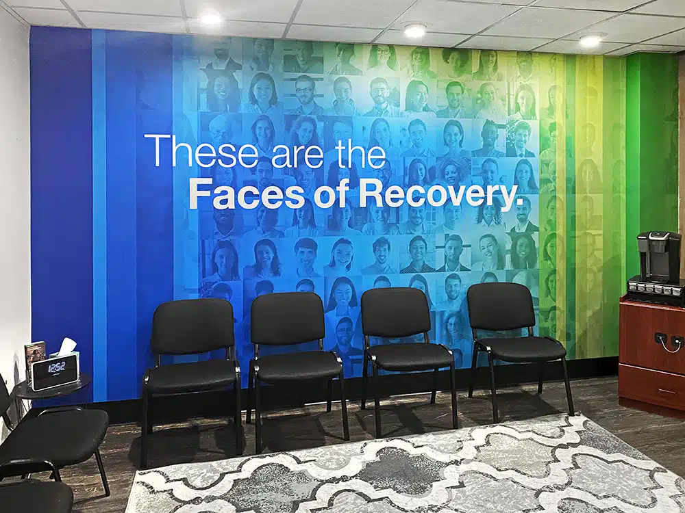Chairs in front of Faces of Recovery mural wall