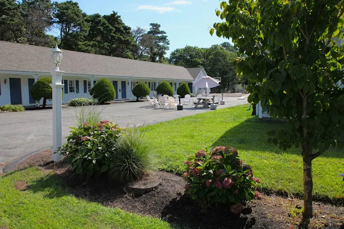 Courtyard with picnic tables, greenery, and guest housing
