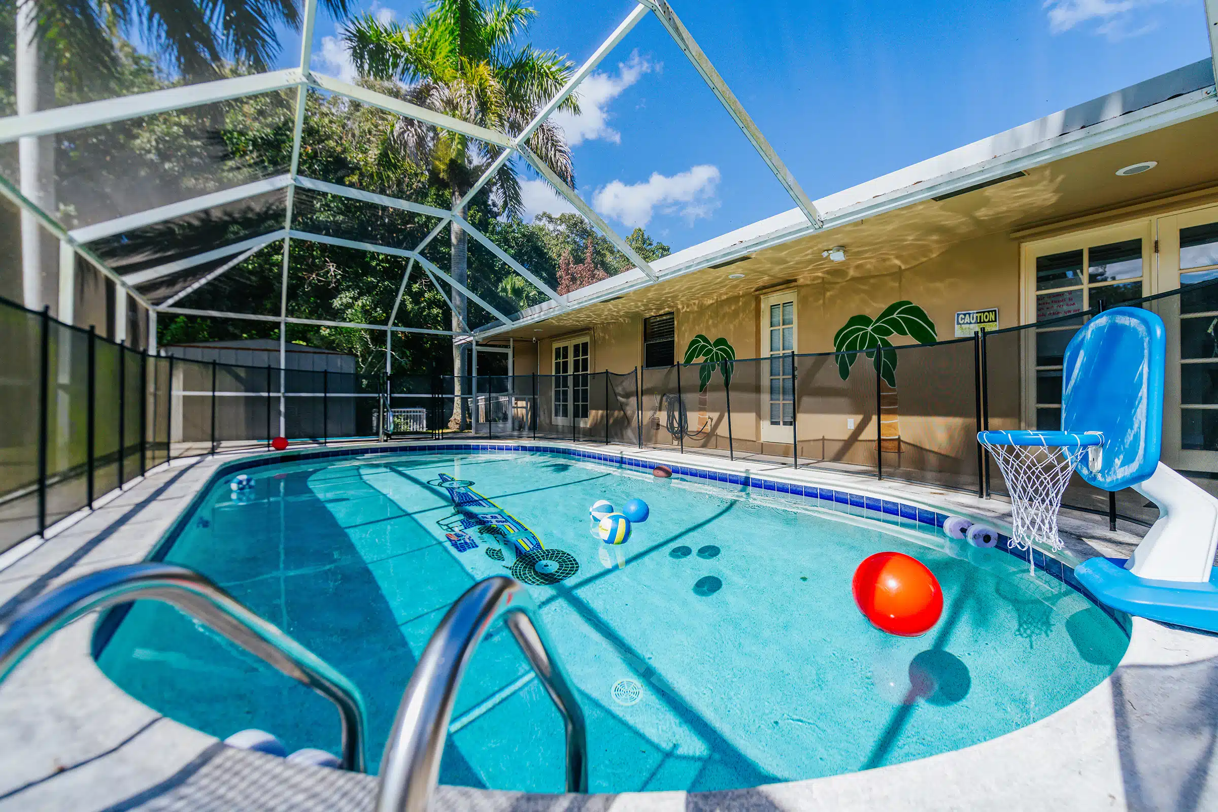Enclosed pool with float toys and basketball hoop