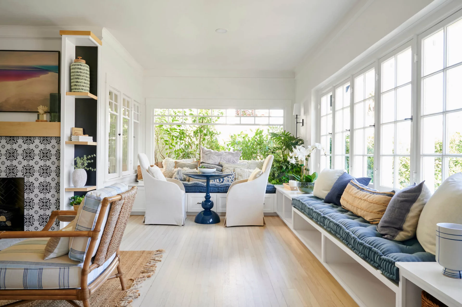 Bright sunroom lounge with cushioned window seating