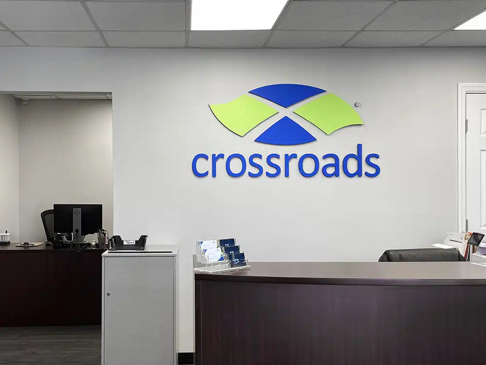 Front desk area with Crossroads logo on wall