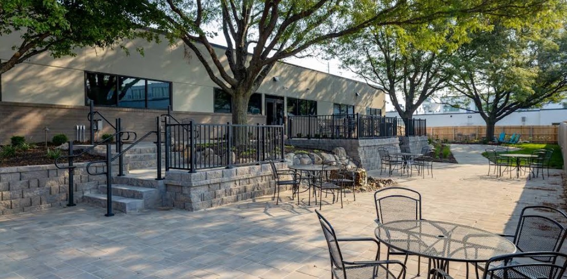 Landscaped outdoor patio with seating and walking areas