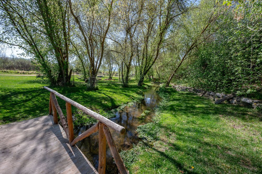 Outdoor area with a bridge over a stream.