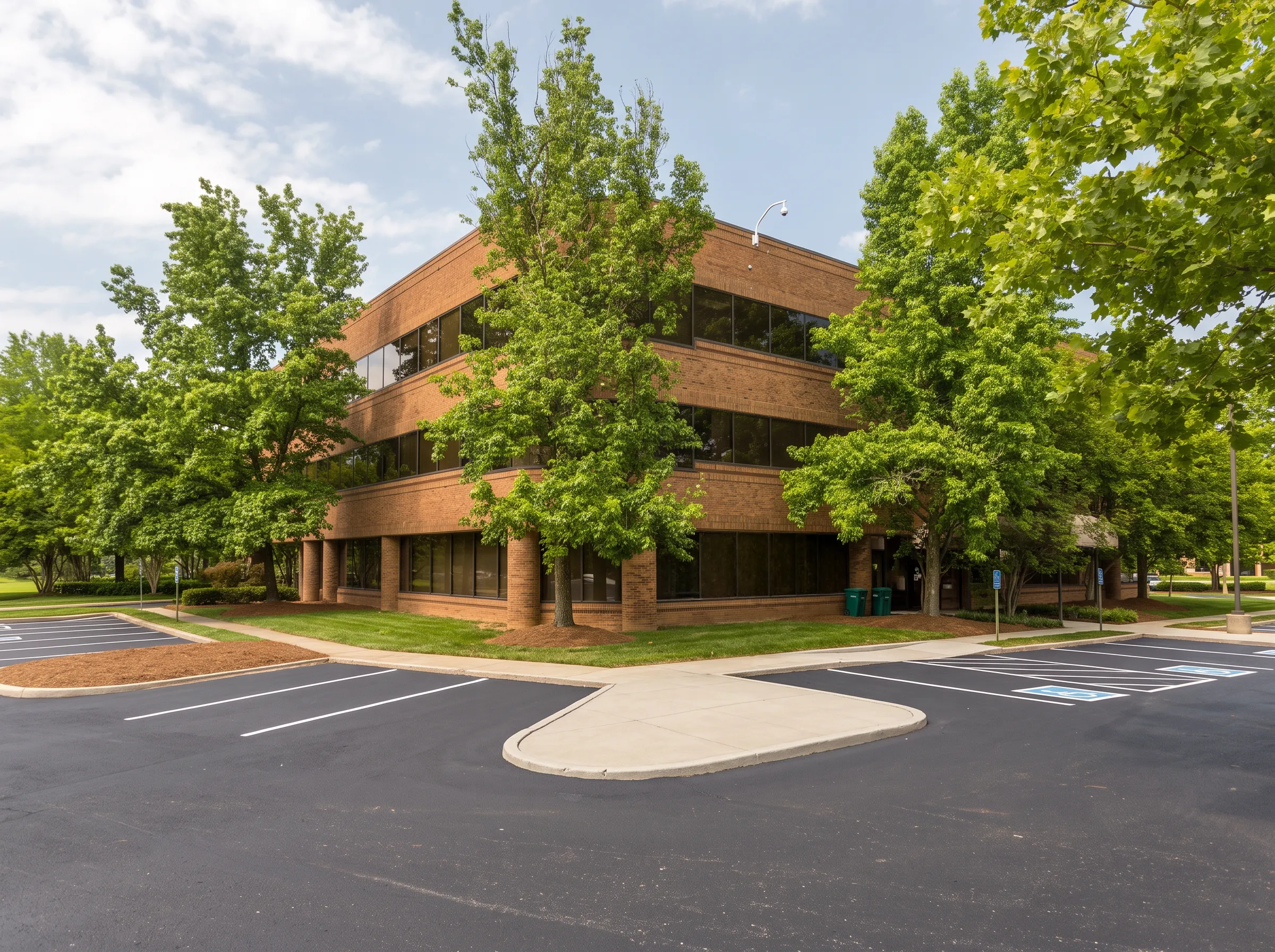 Brick facility building surrounded by mature green trees