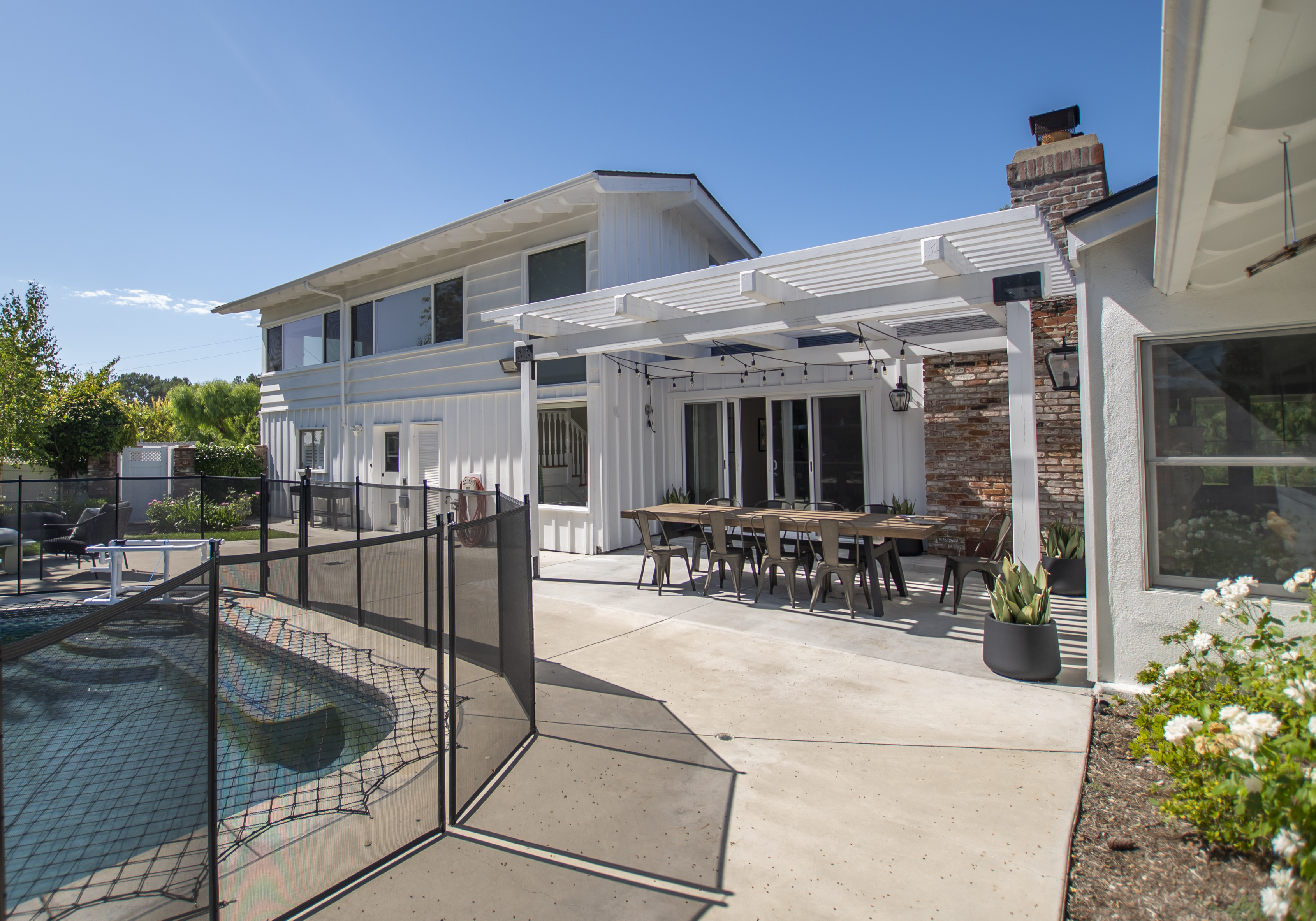 Backyard with pergola, pool, and outdoor seating