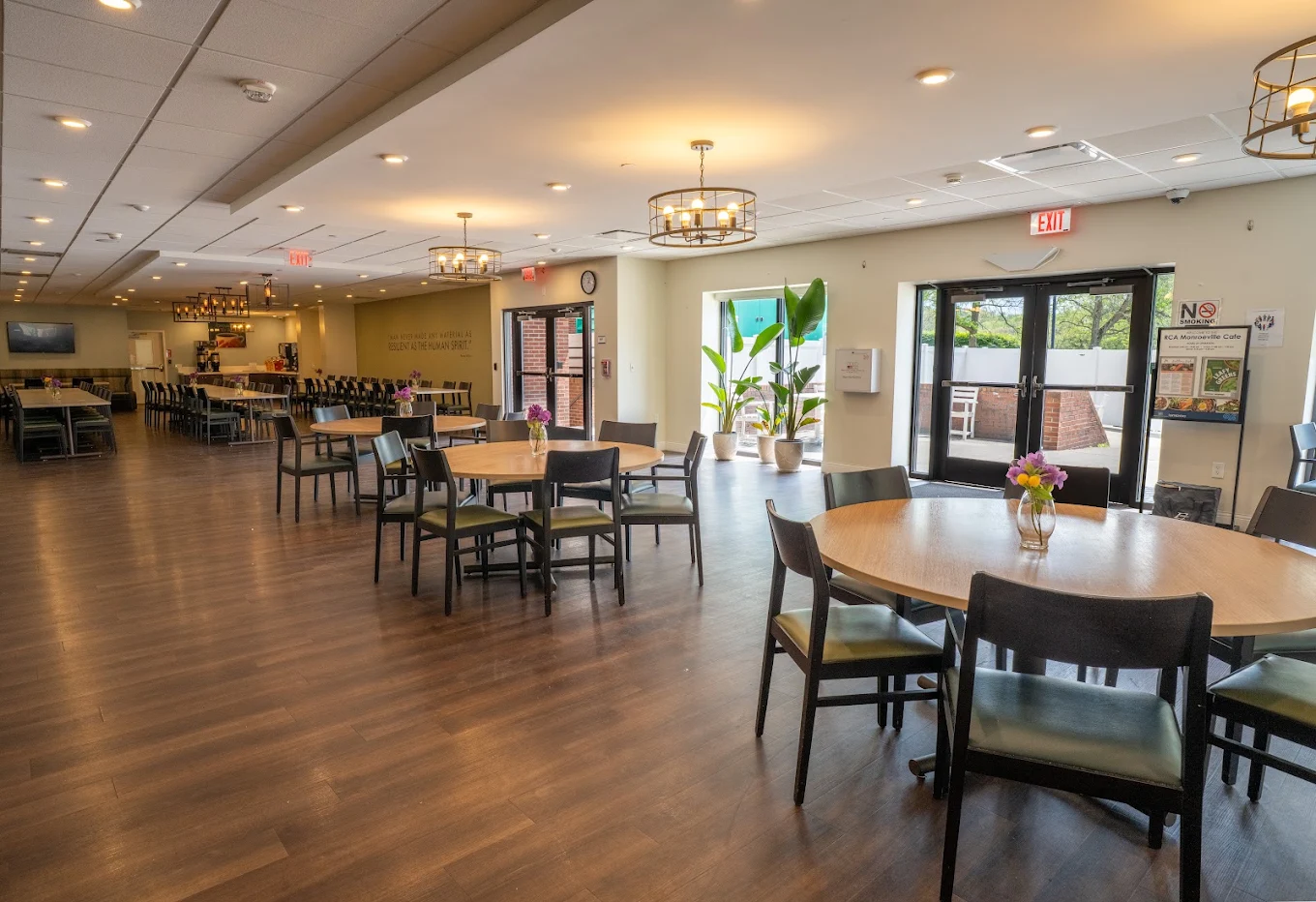 Spacious dining area with tables, chairs, and large windows