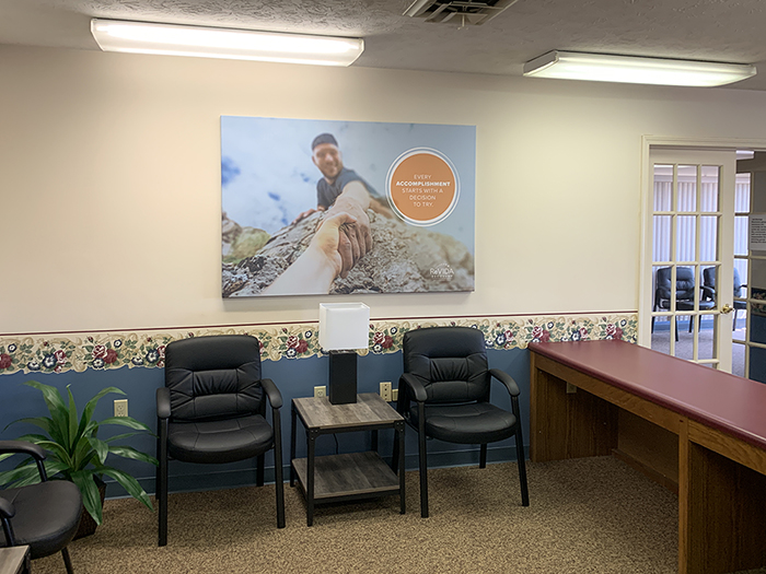 Waiting room with chairs and reception desk in clinic
