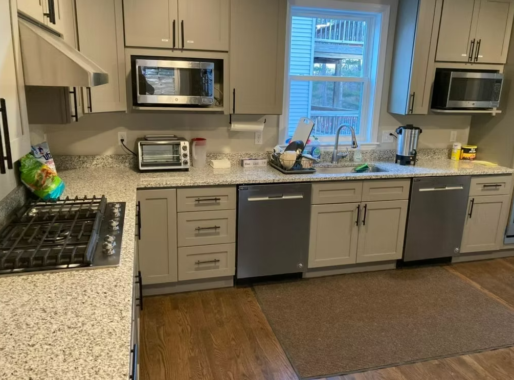 Shared kitchen with appliances, cabinets, and dining prep space