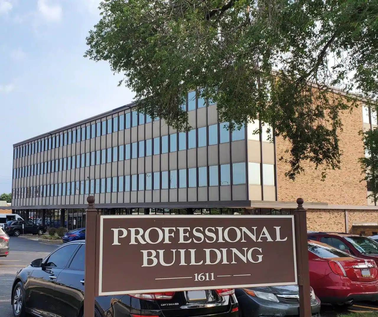 Multi-story office building with professional building sign