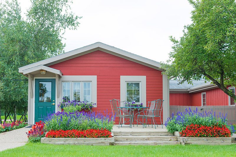 Facility cottage with seating on porch.