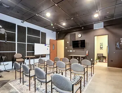Group therapy room with chairs and whiteboard