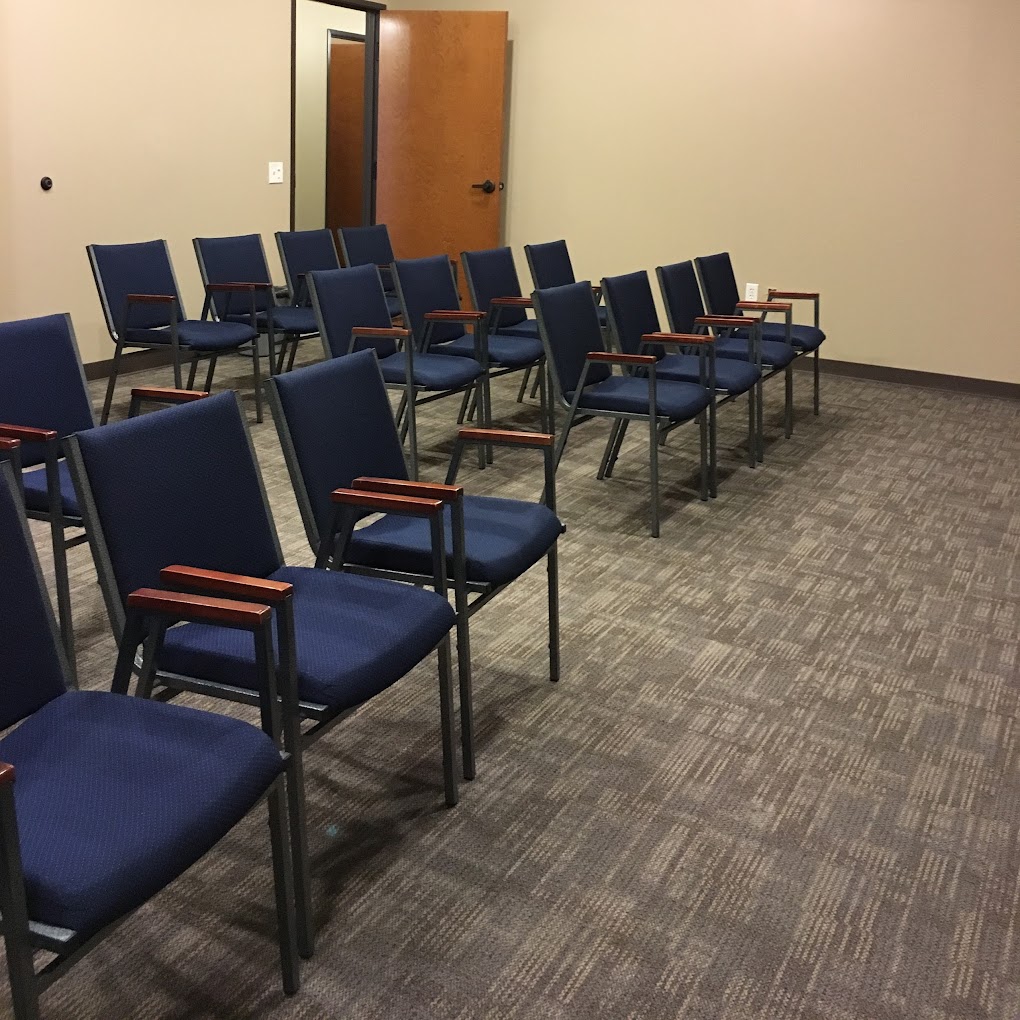 Rows of blue chairs in a group therapy room