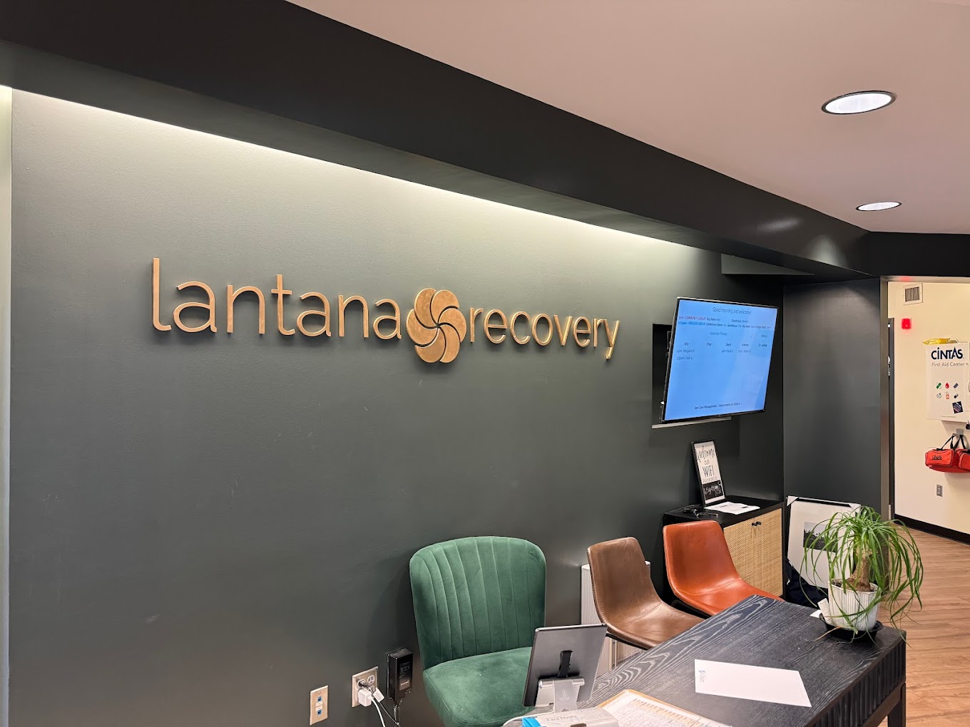 Lantana Recovery reception with a green accent wall and seating area.