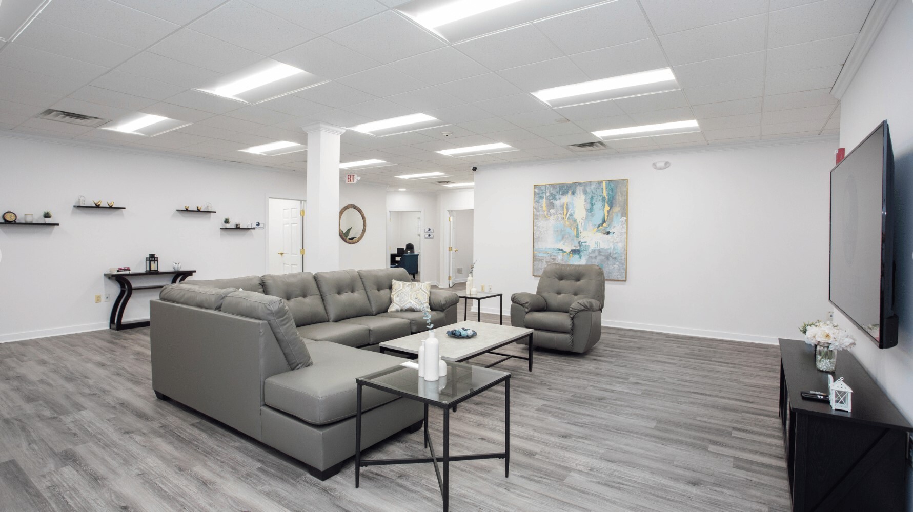 Lounge with couches and tables with a TV.