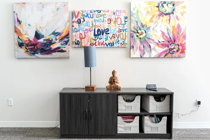 Entryway with colorful artwork and storage cabinet