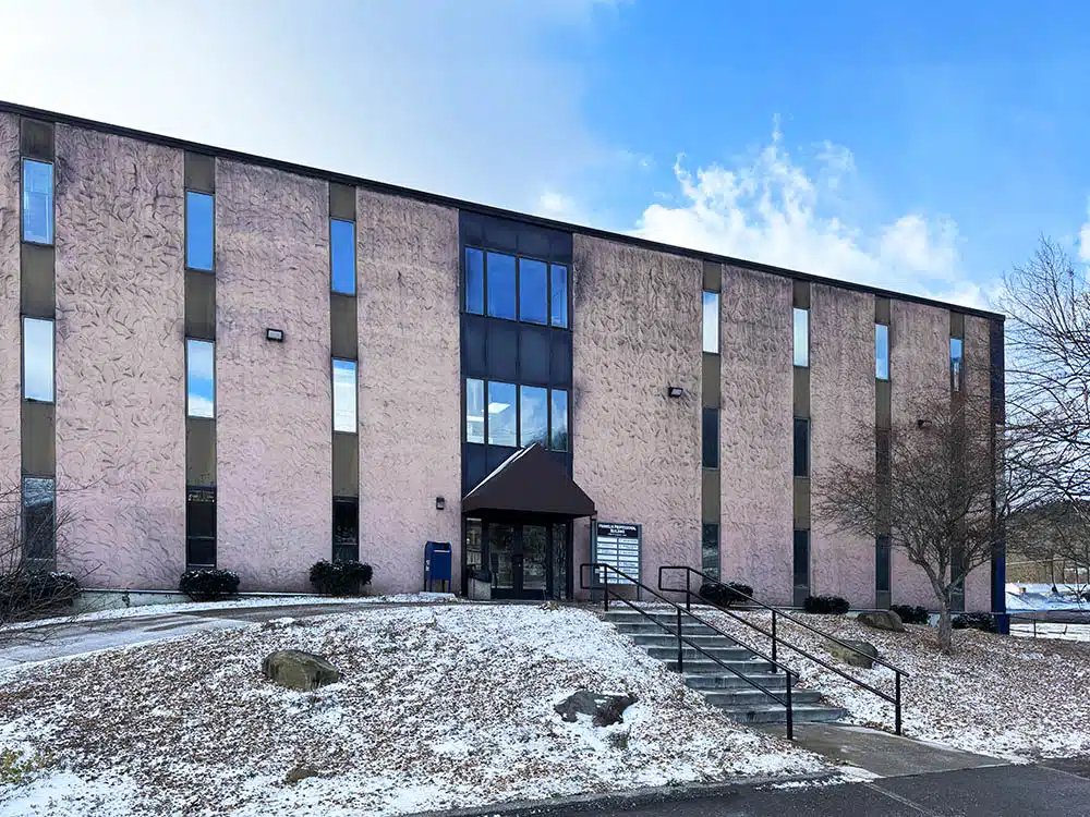 Large clinic building with stairs and snow on ground