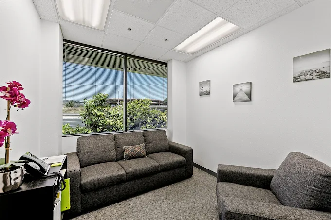 Group therapy room with sofas and whiteboard