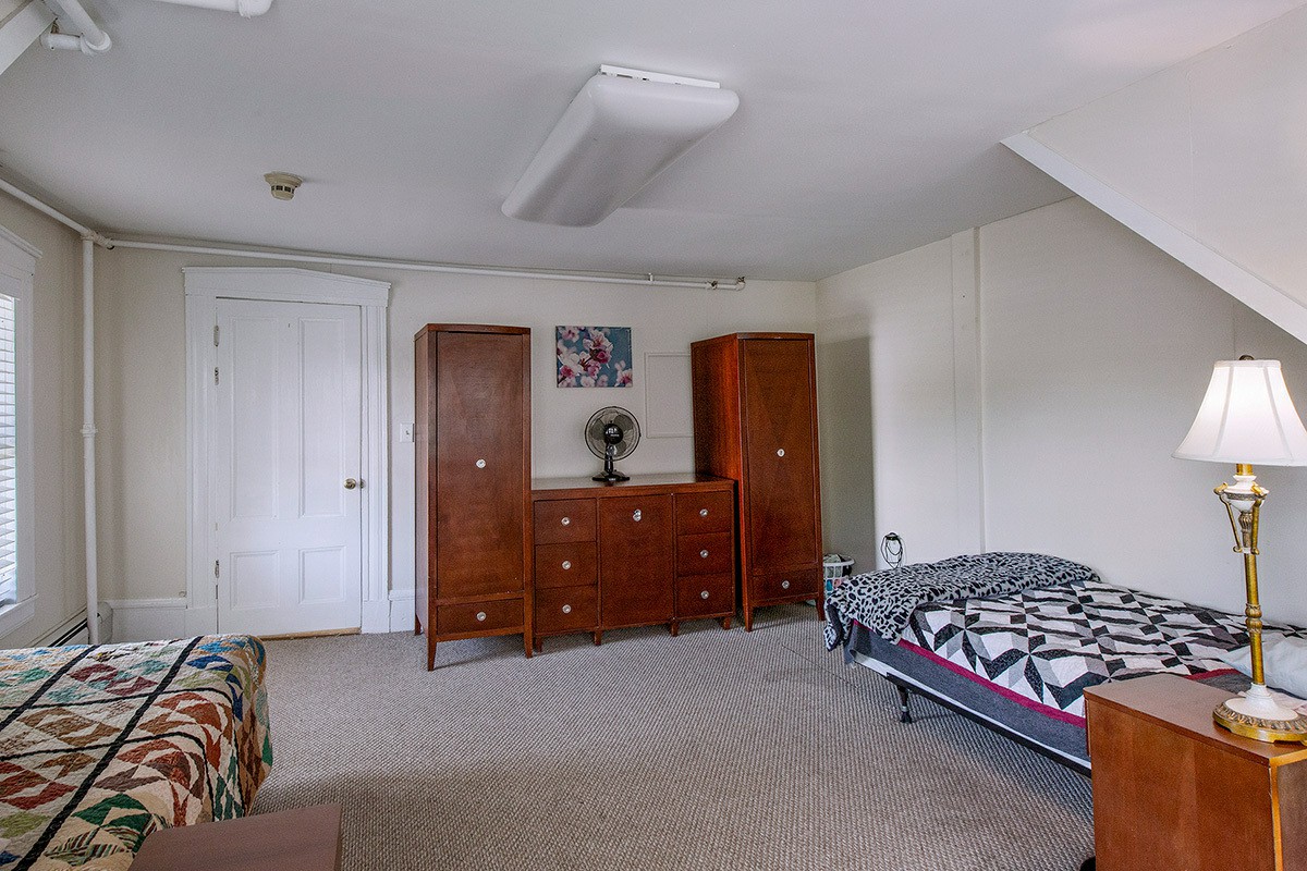 Double bedroom with two beds and dark wood furniture