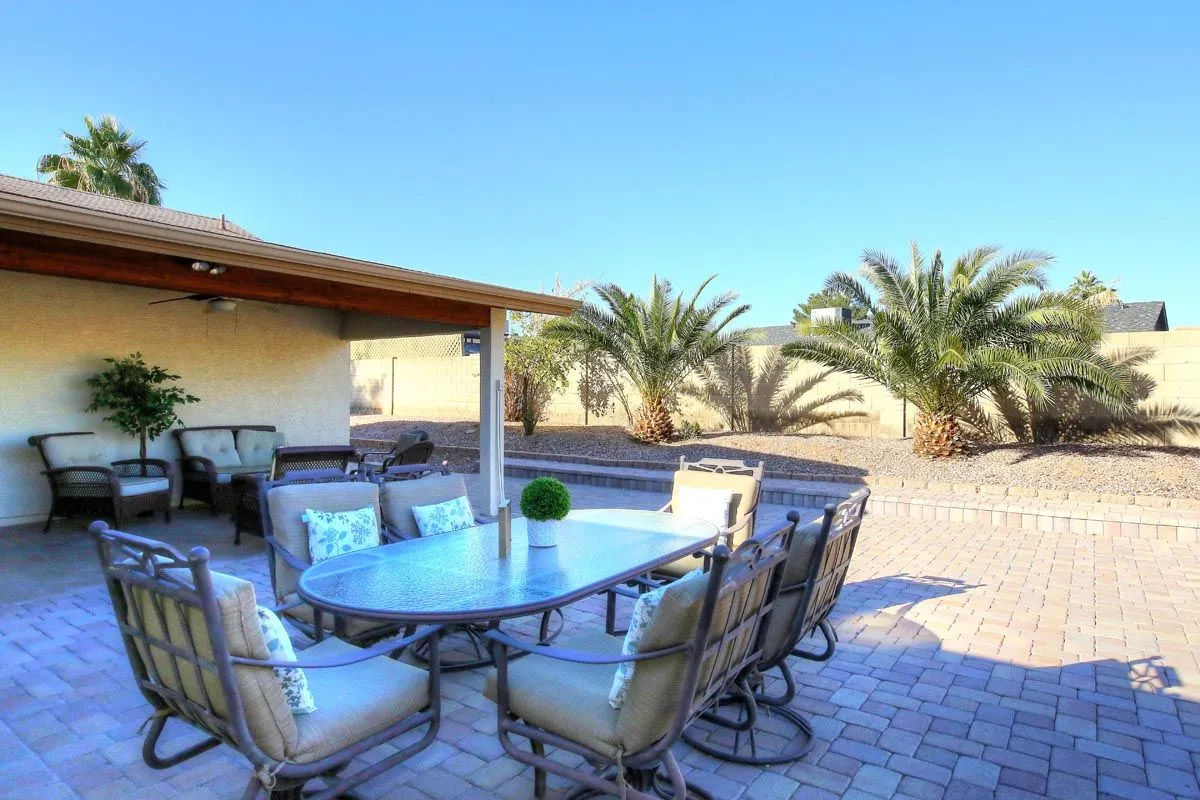 Furnished backyard patio with palm trees at Sanctuary Sober Living Rose Garden in Phoenix