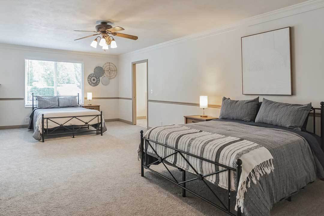 Room with two beds and neutral decor