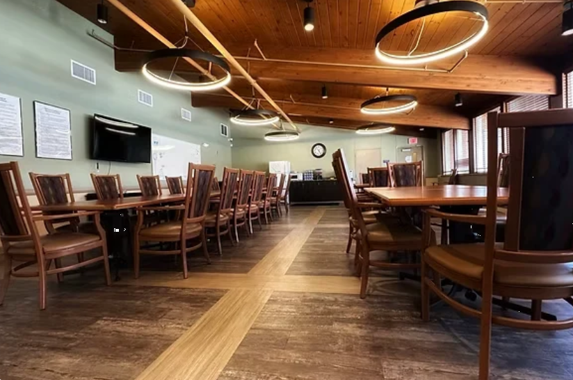 Spacious dining room with wooden tables and chairs