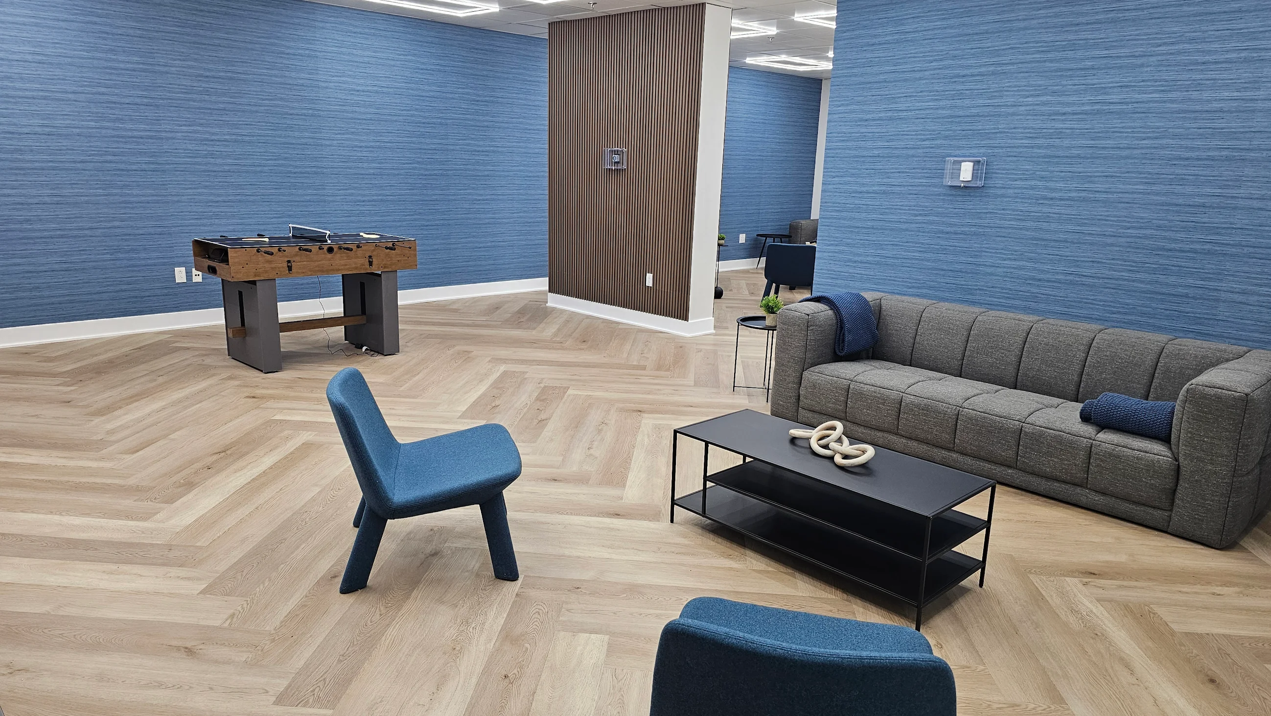 Stylish lounge with foosball table and blue walls