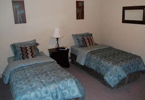 Twin beds with blue bedding and simple wall art